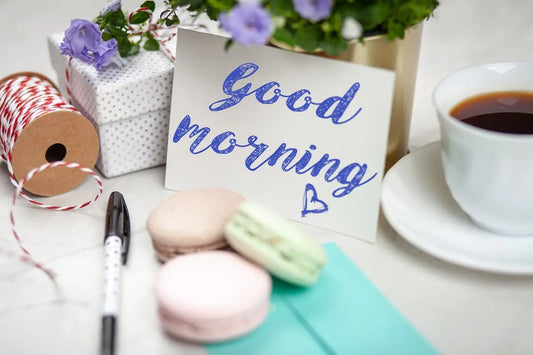 Good morning card with coffee, macarons, and gifts creating a cozy scene