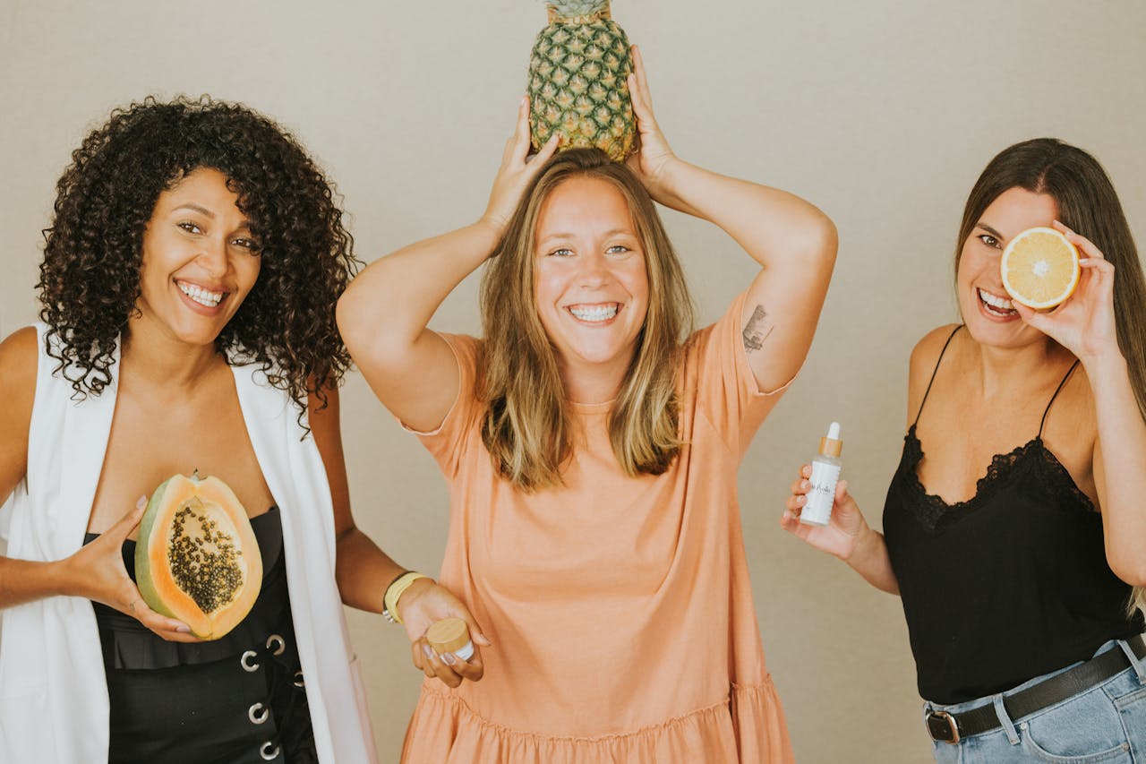 3 healthy women smiling whilst showing vitamins