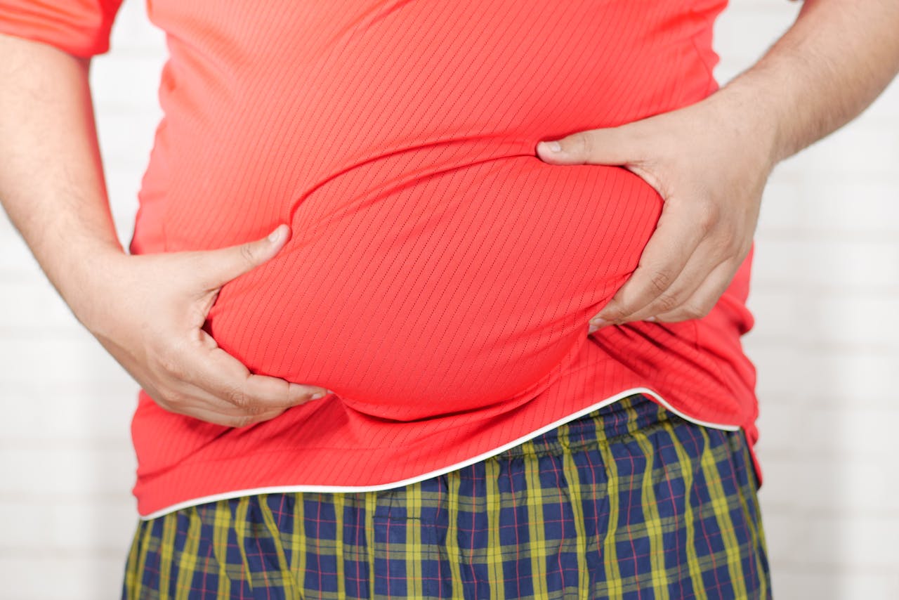 Red t-shirt showing a bloated stomach