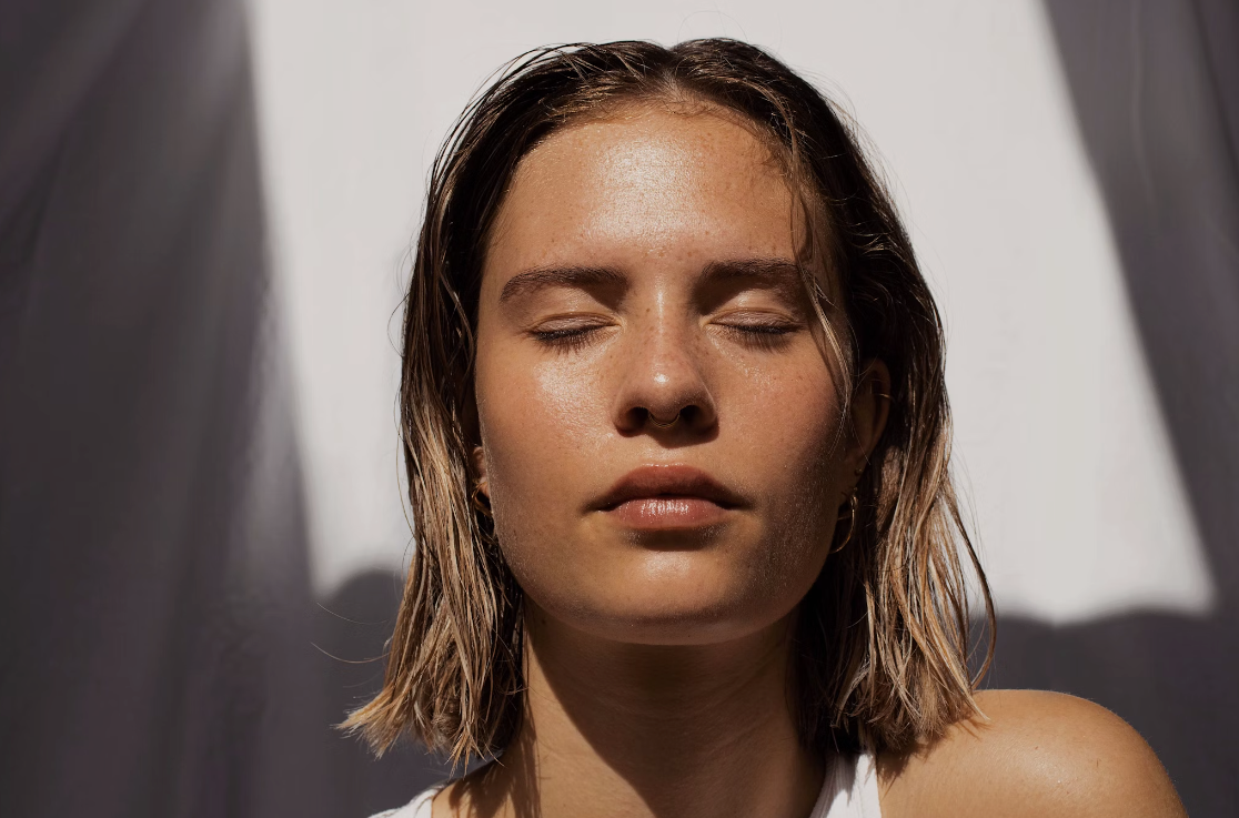 Woman face in sun with good skin and collagen levels in sun