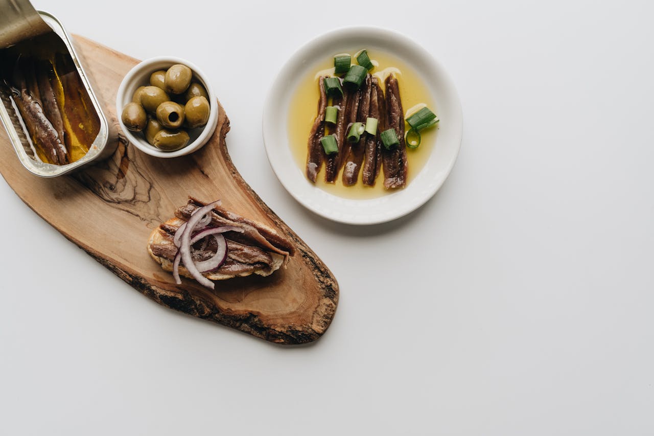 Fish and food snacks on a wooden plate