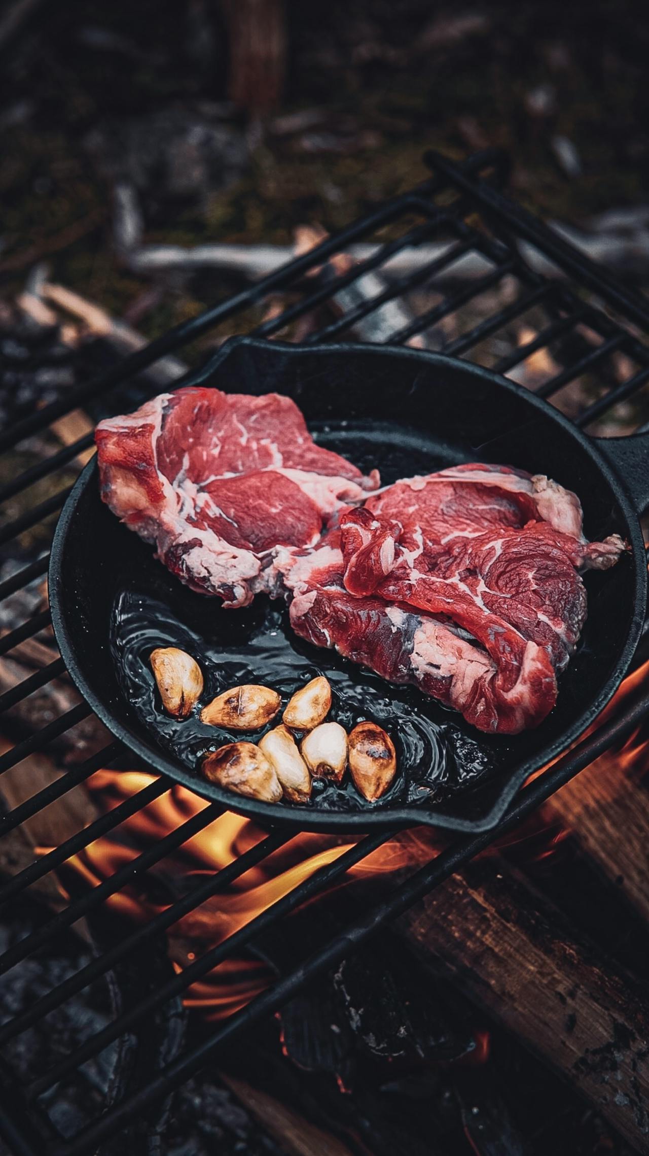 Raw meat cooking in a frying pan